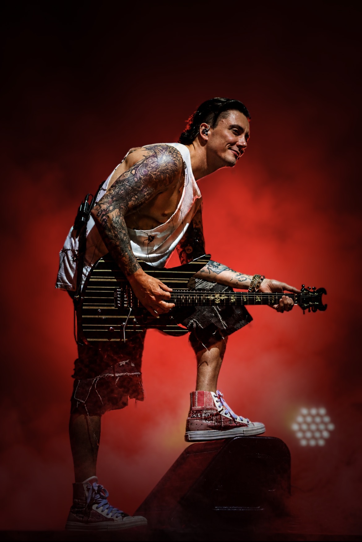Avenged Sevenfold guitarist performing under red lights