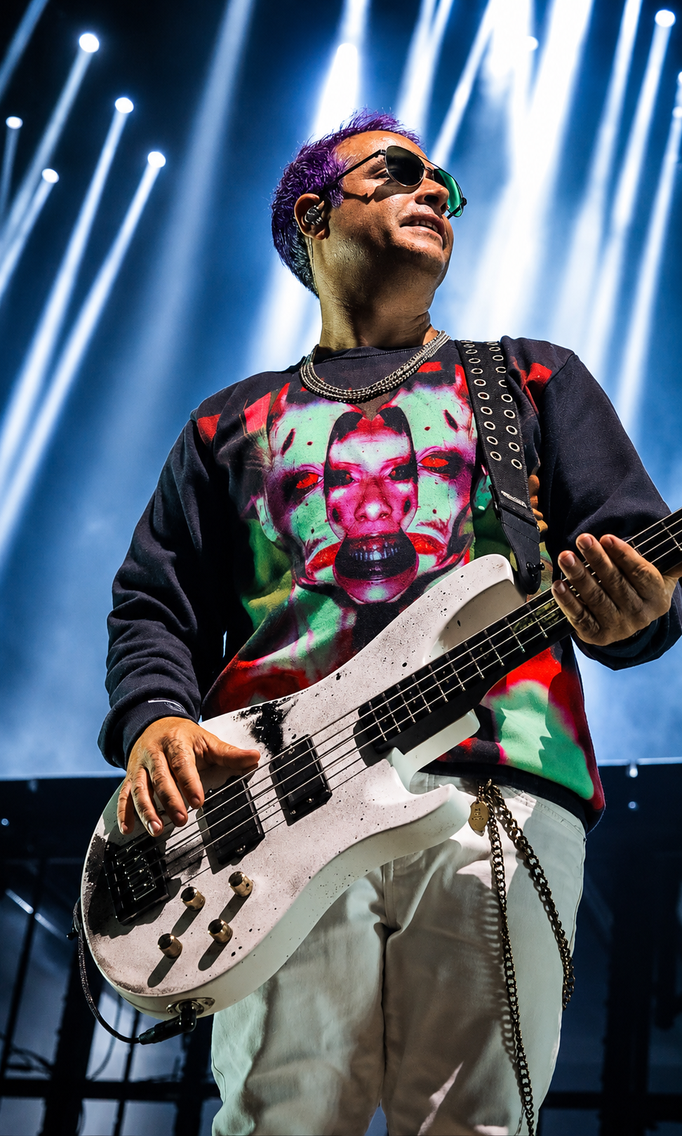 Good Charlotte bassist performing under white stage lights