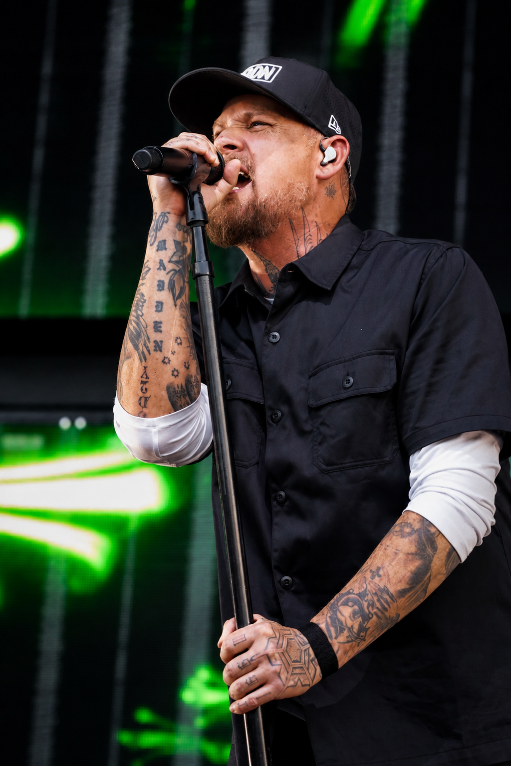 Good Charlotte singer performing in green light